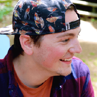 Luke wearing a baseball cap covered in birds