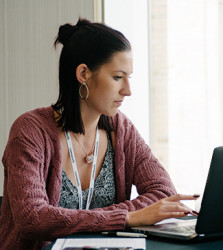 a woman sitting in front of a computer